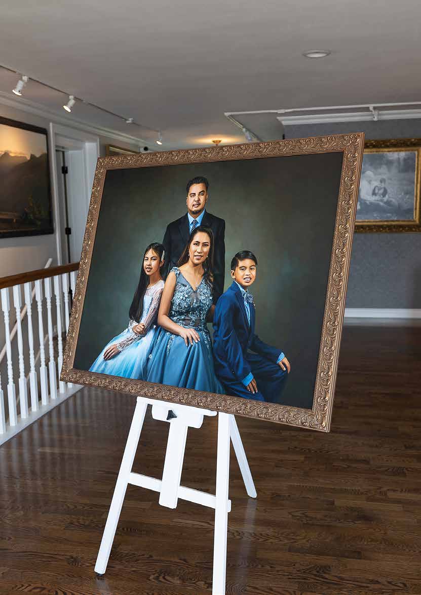 Large commissioned family portrait artwork displayed on an easel
